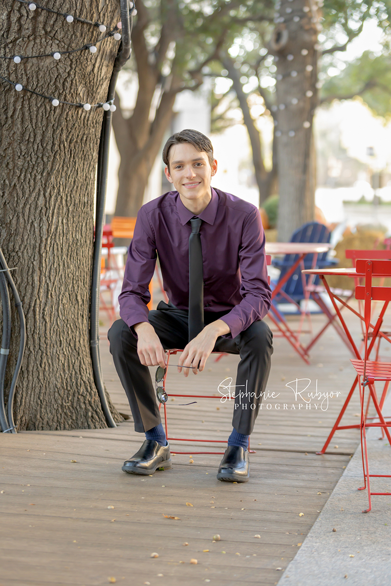 High school senior posing for Homecoming pictures at Burnett Park in Fort Worth. 