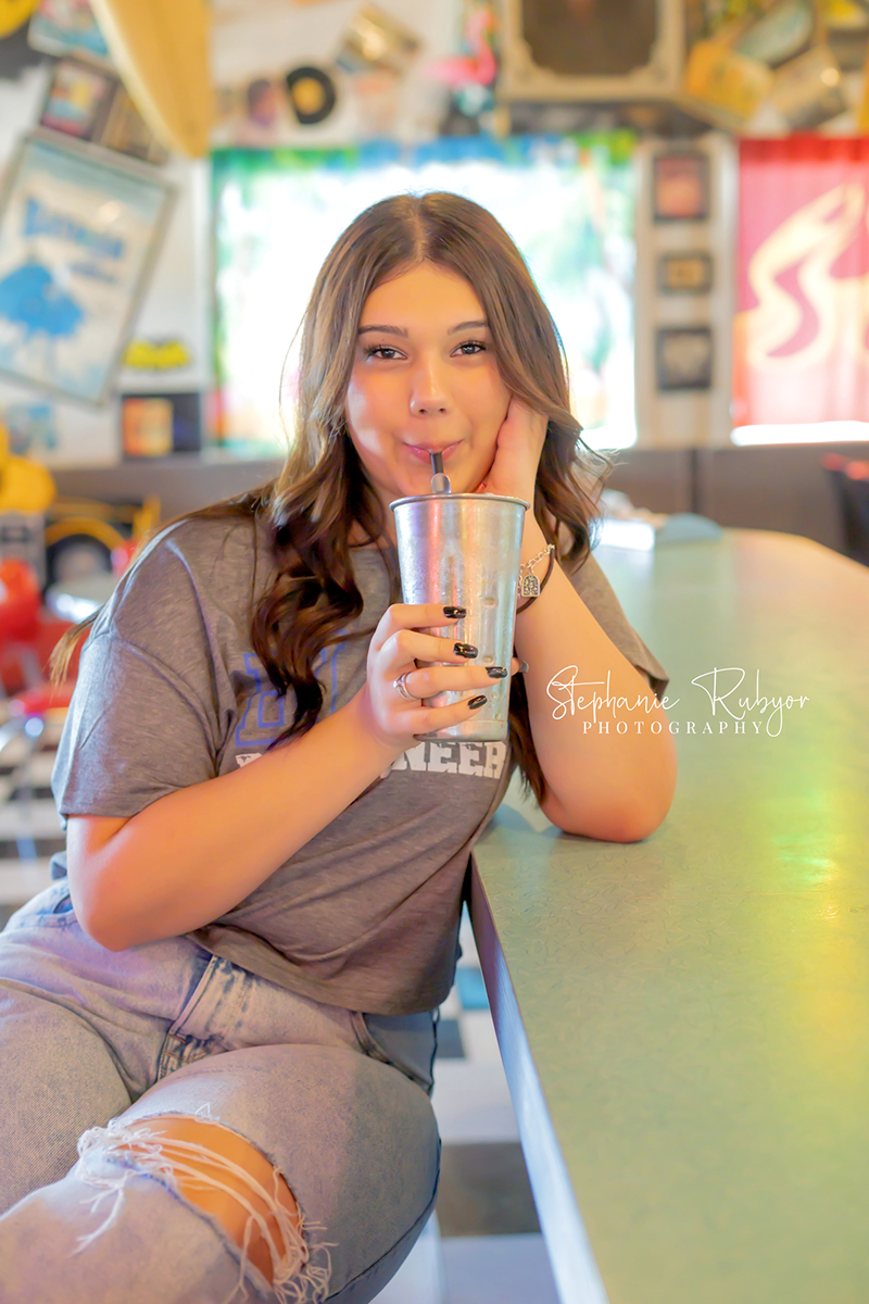 Senior girl posing for senior photo shoot at Yesterdays 50s Diner in Decatur, Texas. 