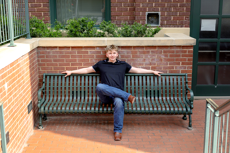 Senior guy posing for high school graduation portraits at Sundance Square.