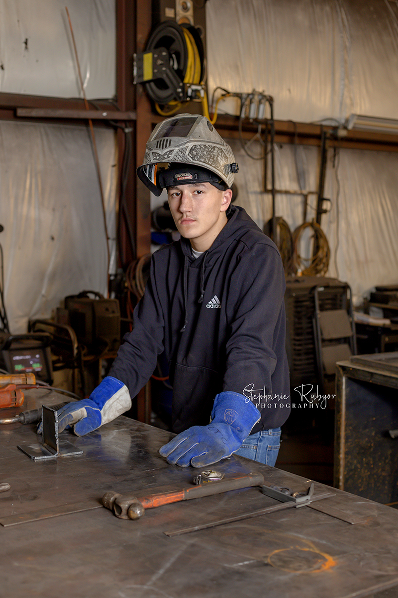 High school senior welding at a local shop for his senior pictures. 