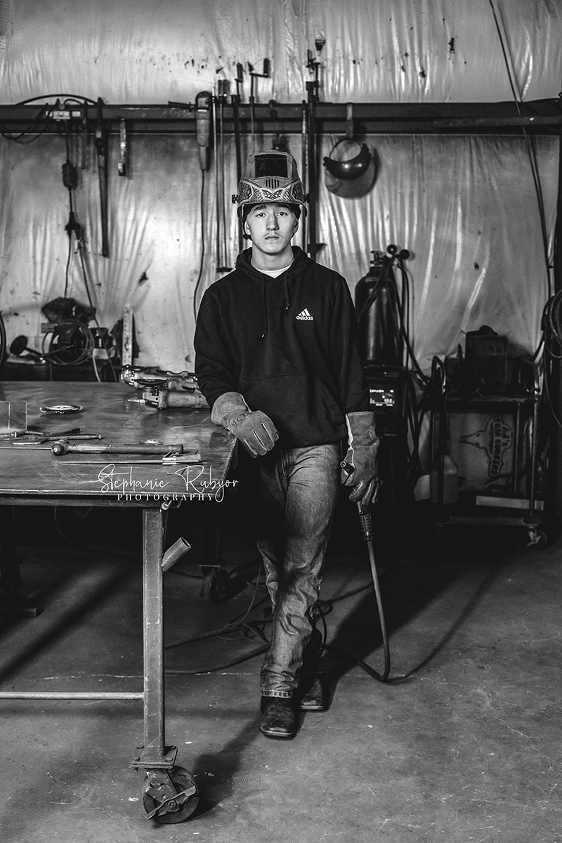 High school senior welding at a local shop for his senior pictures. 