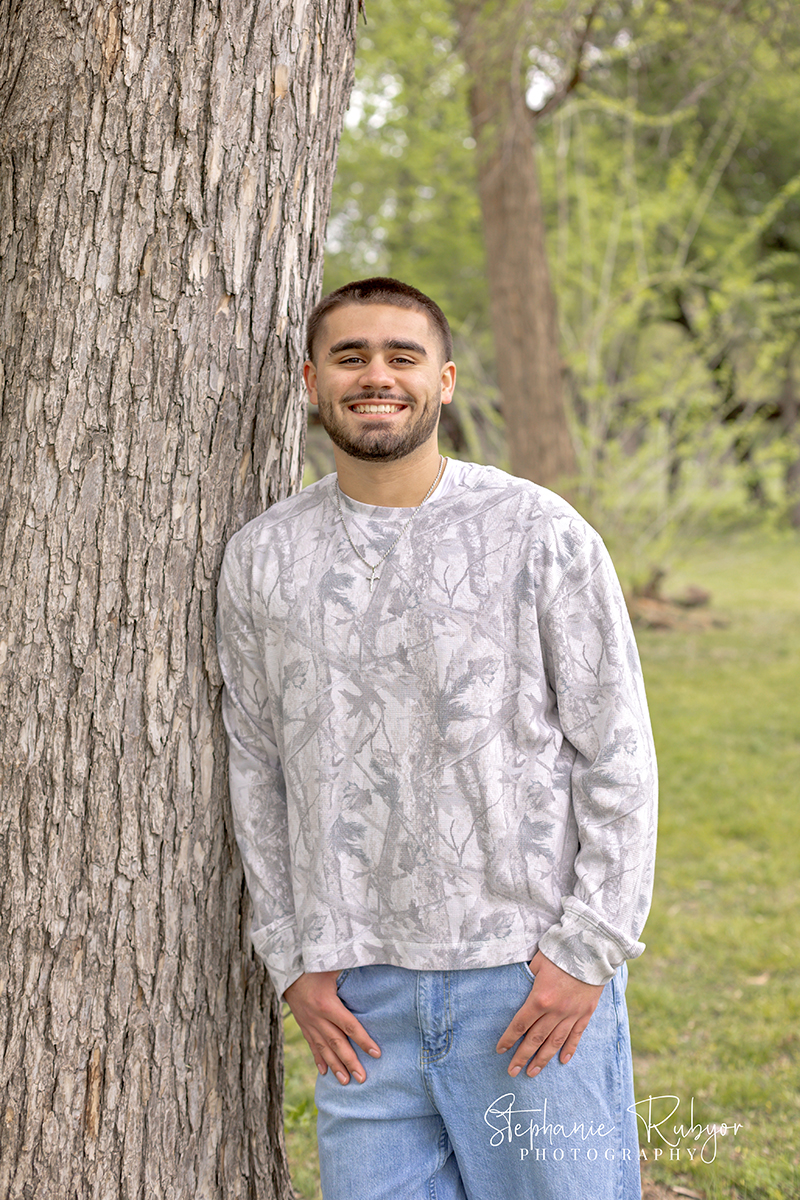 High school senior guy posing for his senior session at Trinity Park in Fort Worth. 