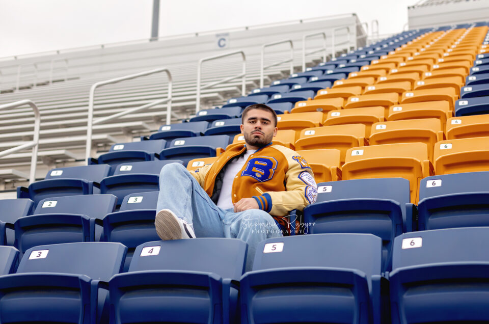 Nate is posing for his senior pictures in his high school football stadium in Saginaw.